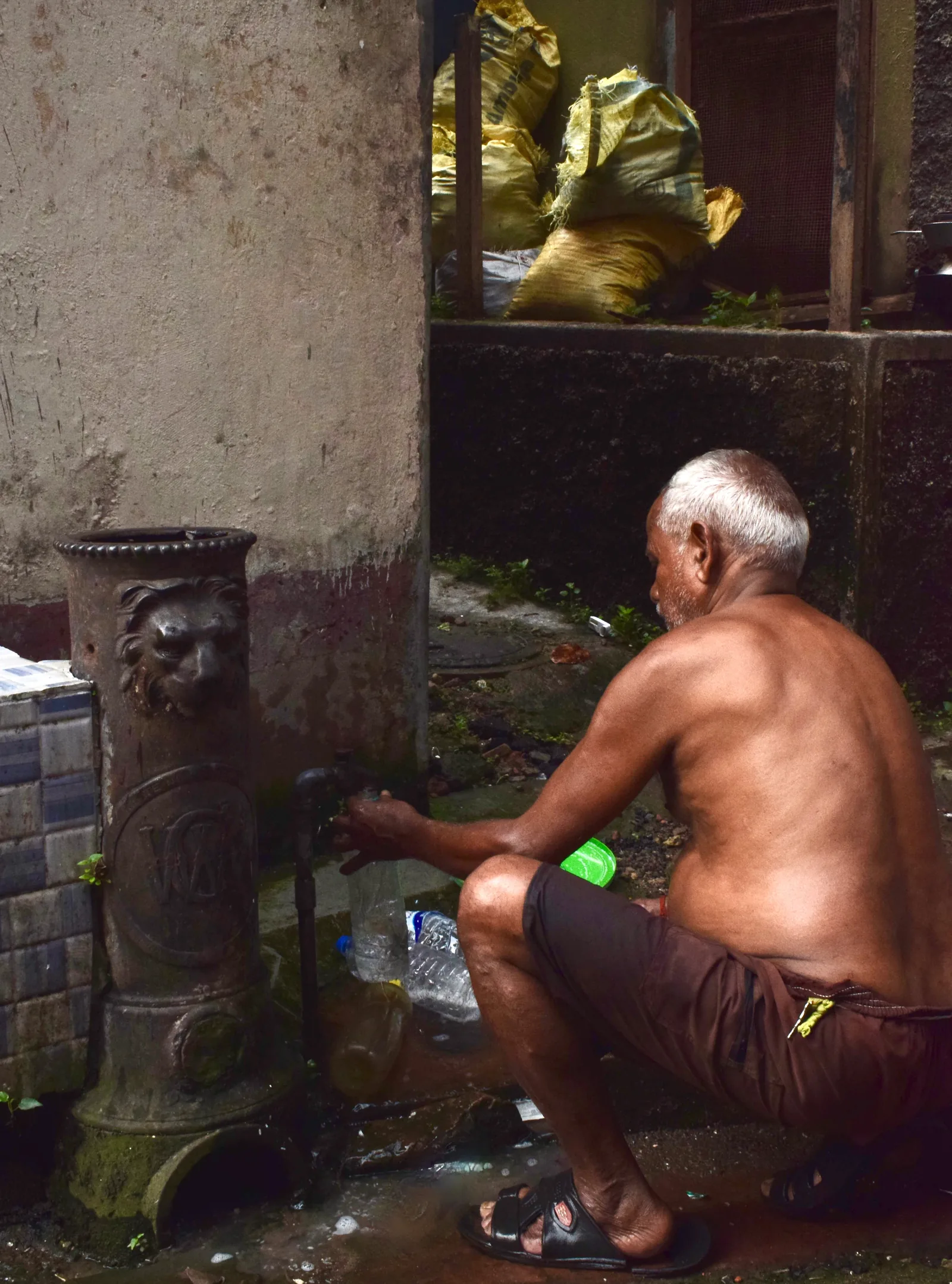 Colonial cast-iron lion water tap old Kolkata street life