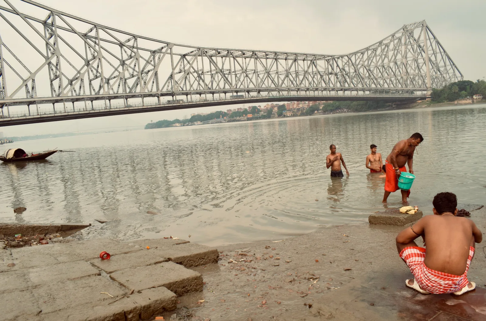 Hooghly riverbank life beneath Howrah Bridge Kolkata