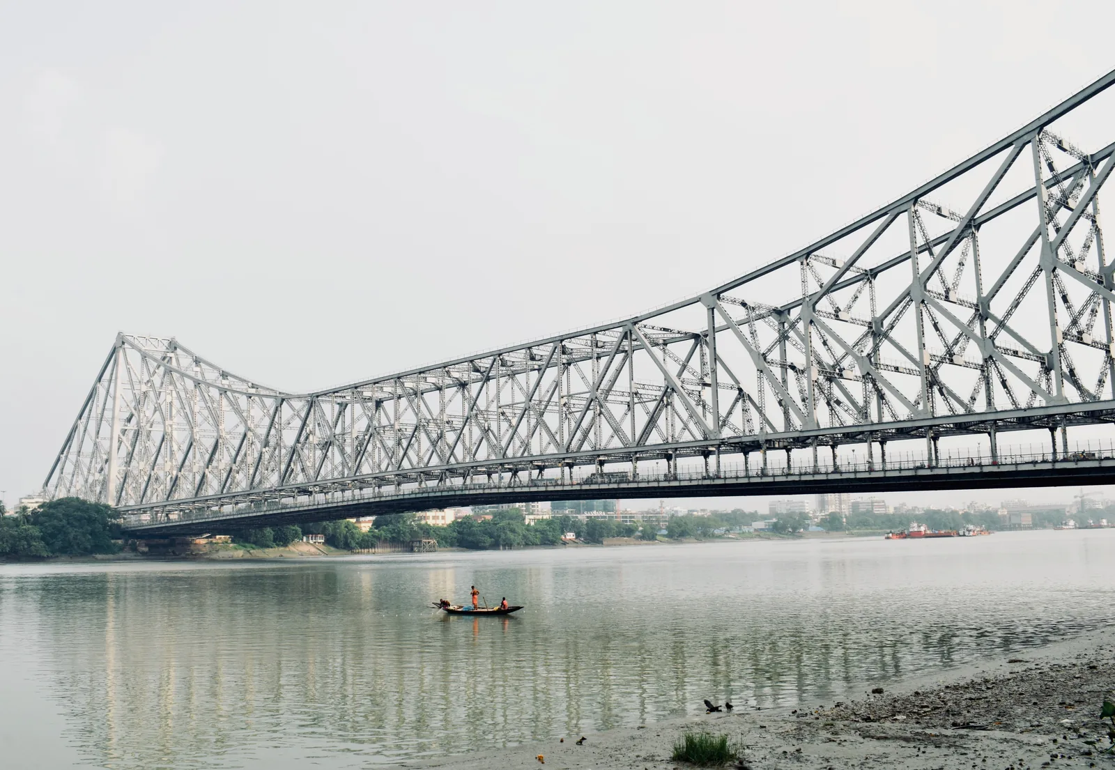 Lone boat on the Hooghly under Howrah Bridge