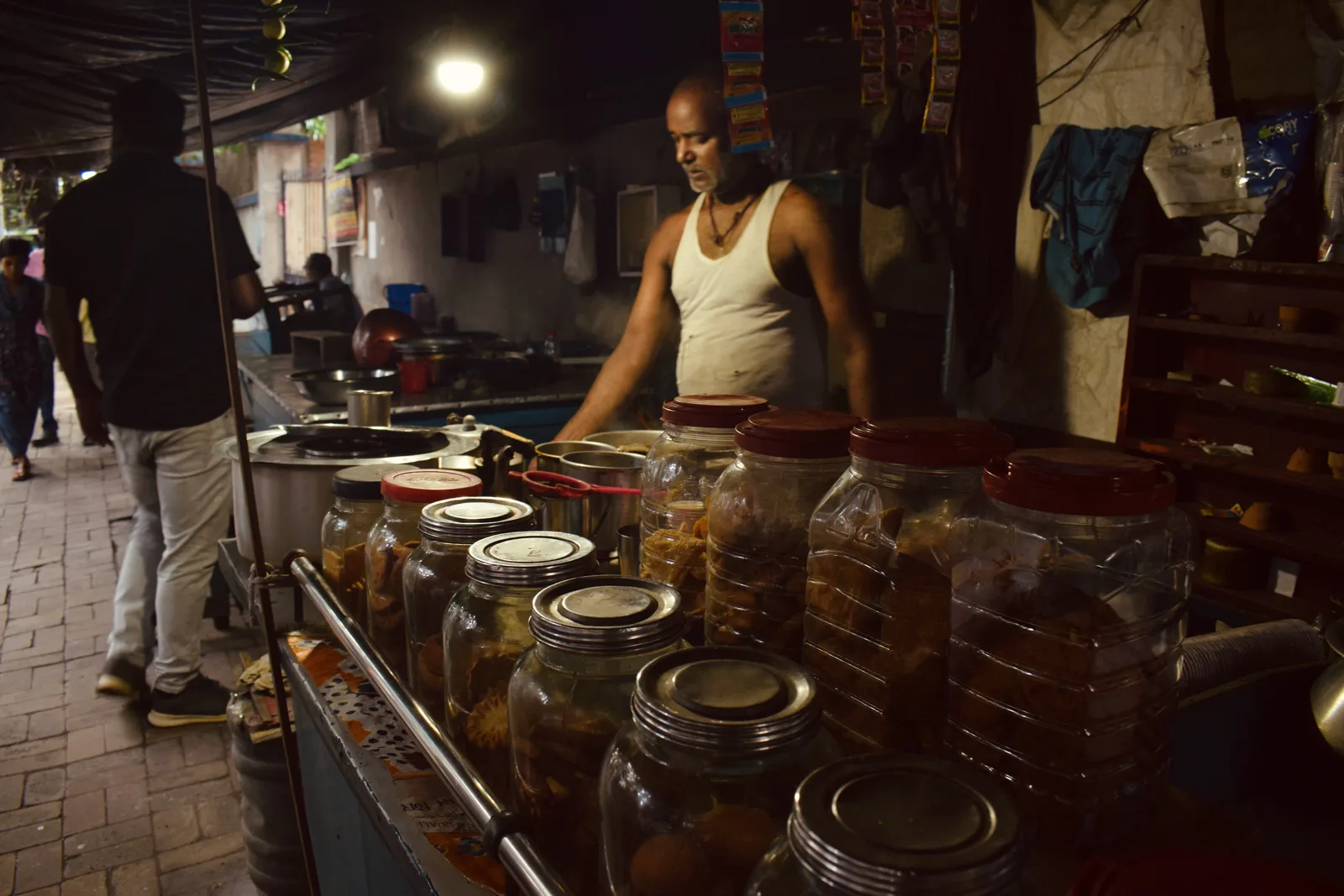 Night snack stall, jars lit by a single bulb